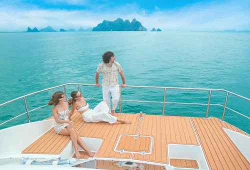 Couple relaxing on luxury yacht deck with scenic ocean views in Phuket.