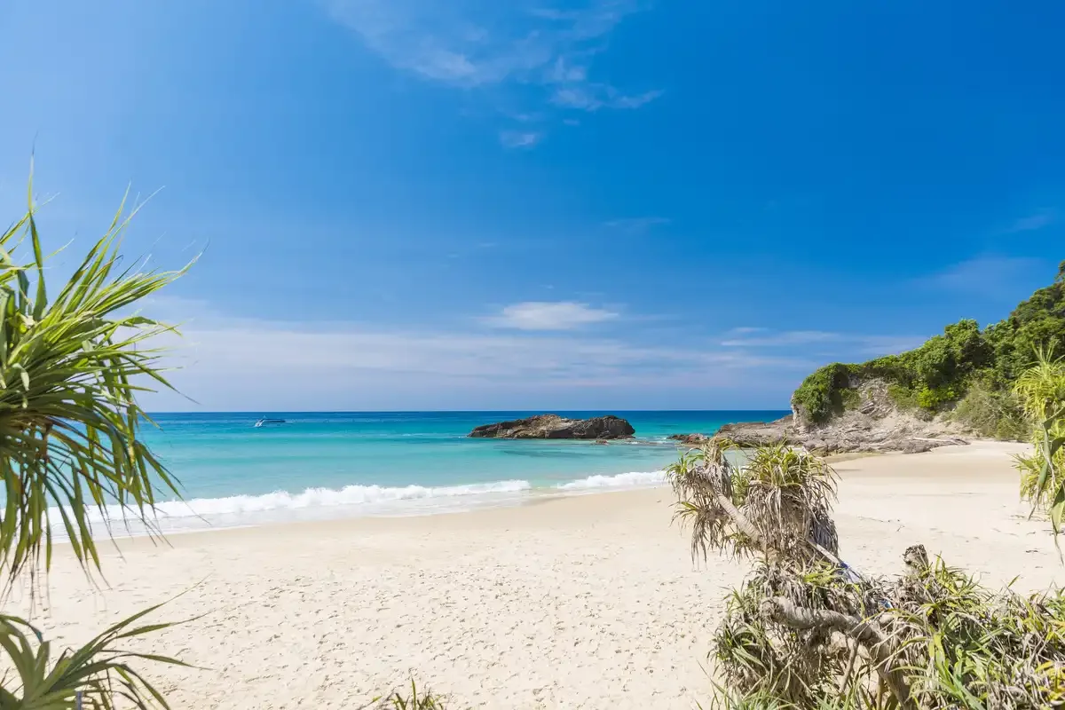 Secluded tropical beach with turquoise waters at Khao Na Yak Phuket Travel Store.