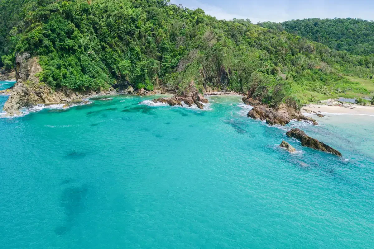 Aerial view of turquoise lagoon and rocky coastline Khao Na Yak Phuket Travel Store.