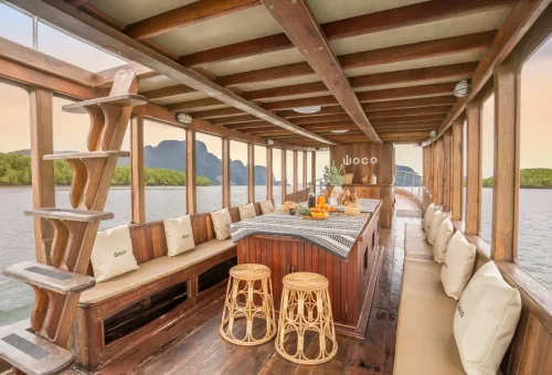 Interior of WOCO boat with seating, fruits, and wooden design for private charter.