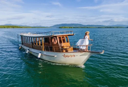 Woman on bow of private longtail boat in Phang Nga Bay