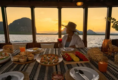 Woman enjoying sunset dinner on private boat in Phang Nga Bay
