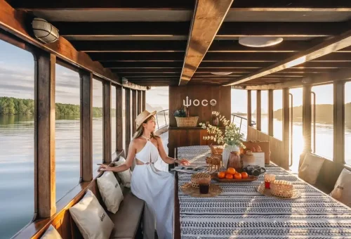 Woman enjoying private luxury boat dining in Phang Nga Bay