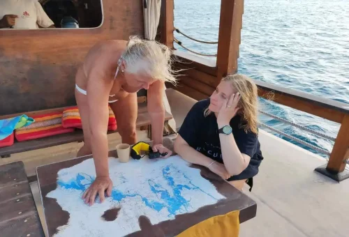 Guests planning route with sea chart on The Cruise Day Tour Phuket