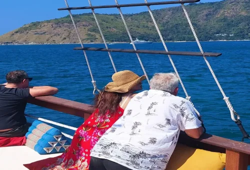 Guests relaxing on deck while sailing The Cruise Day Tour Phuket