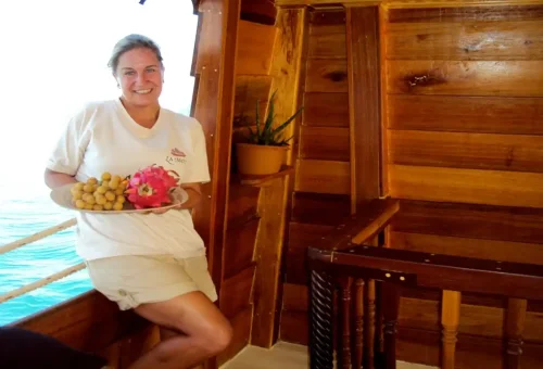Host serving tropical fruits on The Cruise Day Tour Phuket