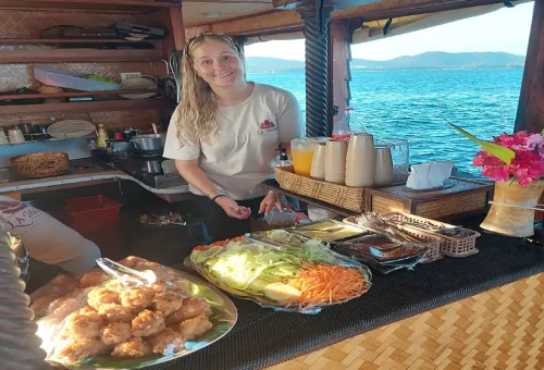 Onboard chef serving Thai food during The Cruise Day Tour Phuket