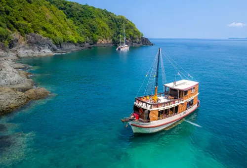Traditional wooden boat La Moet cruising Phuket’s turquoise waters
