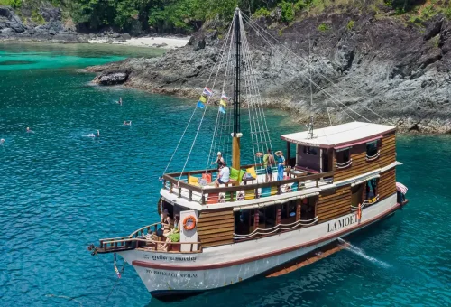 La Moet wooden boat anchored in turquoise Phuket waters