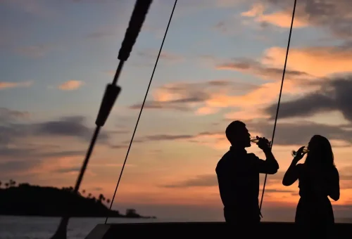 Couple toasting champagne during Phuket sunset cruise