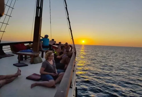 Guests capturing photos of Phuket sunset at sea
