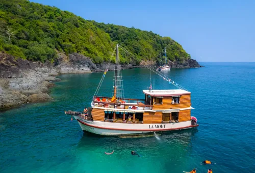 Traditional wooden boat La Moet anchored in turquoise waters