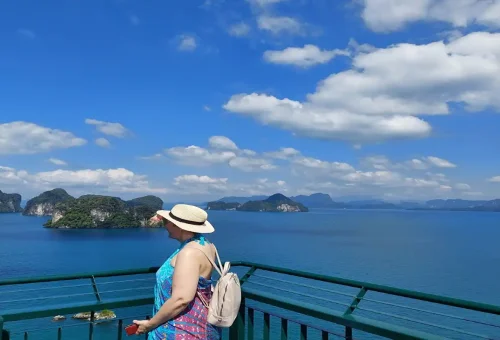 Tourist enjoying panoramic sea view from Koh Hong viewpoint on a Phuket day trip.