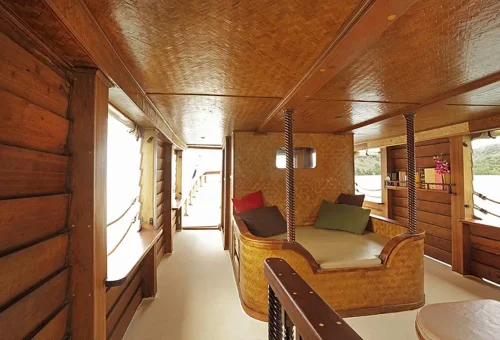 Bamboo-style lounge area with cushions aboard Phuket Travel Store’s day cruise boat.