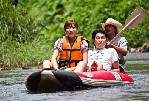 Couple enjoying a guided canoe trip on the river at Khao Sok National Park with Phuket Travel Store.