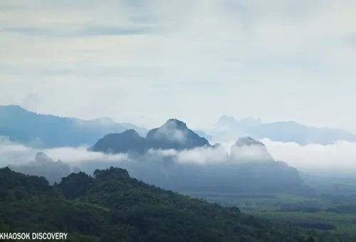 Mist over limestone mountains at Khao Sok National Park viewpoint.
