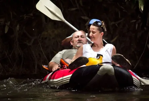 Couple enjoying a relaxing canoe ride on Khao Sok River with Phuket Travel Store.