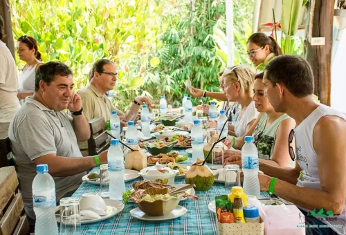 Travelers enjoying a Thai buffet lunch at Khao Sok Discovery Restaurant during Phuket Travel Store day trip.