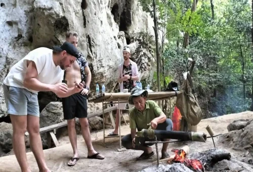 Tourists drinking bamboo coffee during Khao Sok jungle and canoeing day trip.