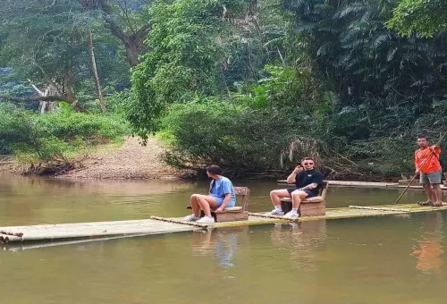 Couple relaxing on a bamboo raft in Khao Sok River