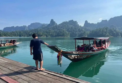 Tourists boarding a longtail boat at the Cheow Lan Lake pier.