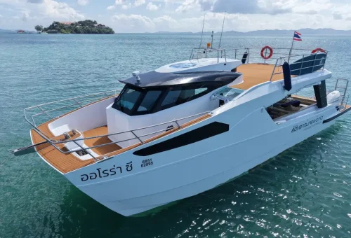 Modern catamaran yacht anchored in turquoise waters for Phang Nga Bay Sunset Serenity Cruise with Phuket Travel Store.