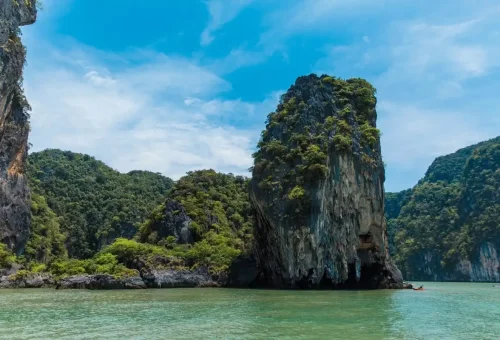 Limestone karst cliffs rising from the emerald sea at Hong Island, Krabi.