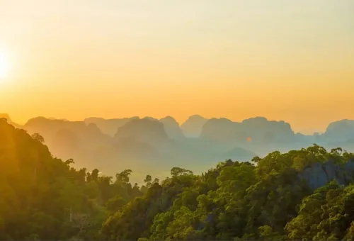 Sunset view over Krabi limestone mountains from Tiger Cave Temple viewpoint.