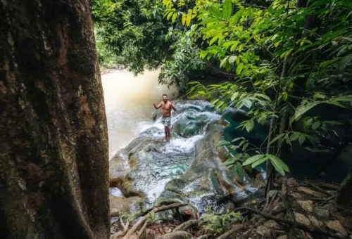 Traveler enjoying the natural Krabi hot springs in the jungle.