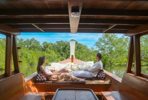 Couple relaxing on private longtail boat in Phang Nga Bay mangroves