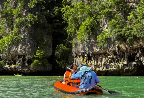 Sea kayak paddling through limestone cliffs in Phang Nga Bay