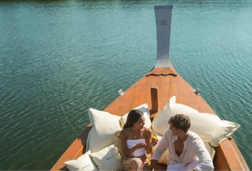 Couple relaxing on private longtail boat deck in Phang Nga Bay