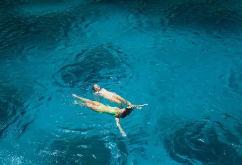 Tourists floating in turquoise waters at Raya Yai Island