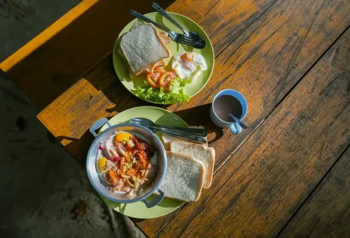 Traditional Thai breakfast with eggs, bread, and coffee before island adventure on Surin Islands tour.