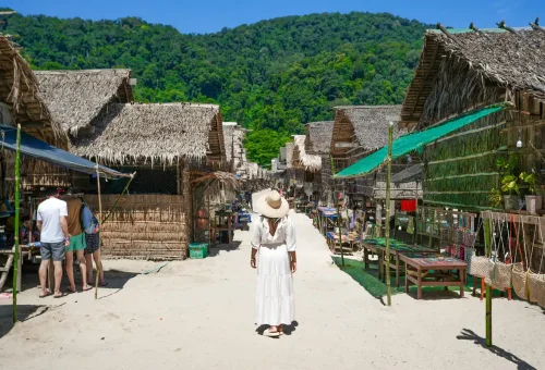 Tourist exploring Moken sea gypsy village Surin Islands Thailand