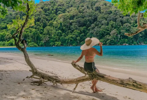 Woman relaxing on white sandy beach at Surin Islands Thailand