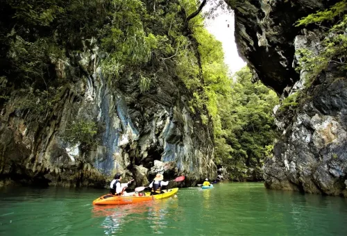 Couple kayaking between limestone canyons in Ao Thalane Krabi