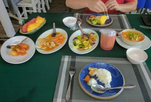 Traditional Thai lunch with curry, rice, and tropical fruit in Krabi