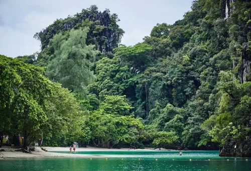 Hidden lagoon surrounded by limestone cliffs at Ao Thalane Bay in Krabi, Thailand.