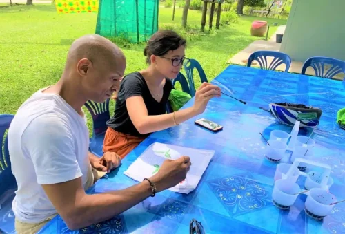Tourists painting batik at Koh Klang cultural workshop