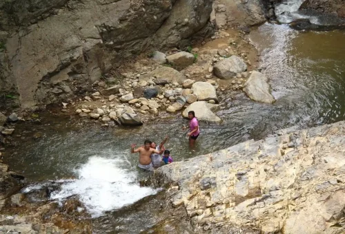 Visitors enjoying swimming in a natural pool at Huay Tho Waterfall Krabi.