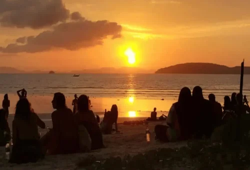 Sunset view at Ao Nang Beach with people relaxing on the sand at the Krabi 7 Islands Tour