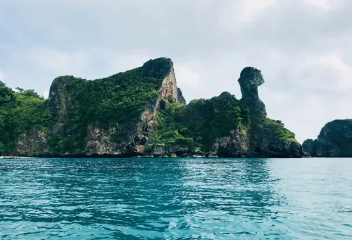 Chicken-shaped rock formation at Chicken Island Krabi with deep blue tropical water