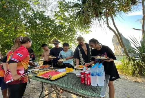 Tourists enjoying a Thai BBQ dinner on the beach during the Krabi 7 Islands Sunset Tour.