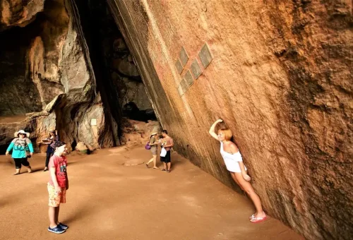 Tourists exploring prehistoric rock paintings, part of the James Bond Discovery Tour from Krabi.