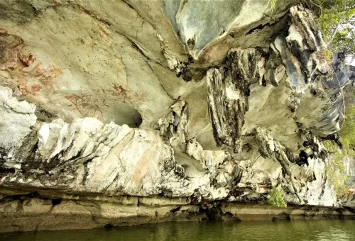 Prehistoric red rock drawings on cave walls seen during the James Bond Discovery Canoeing Tour.