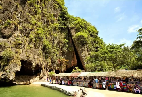 Local souvenir stalls under limestone cliffs on Khao Phing Kan Island, near James Bond Island.