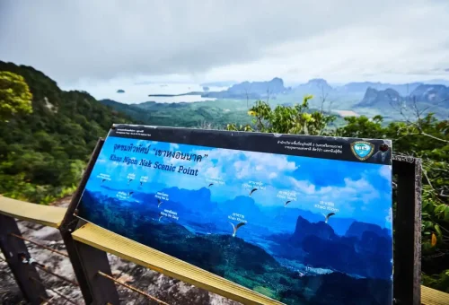 Khao Ngon Nak Scenic Point signboard overlooking Krabi’s mountain range and sea view.