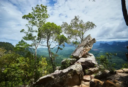 Viewpoint rocks and tropical trees on Dragon Crest Mountain overlooking Krabi’s green valley.