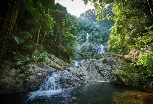 Wide view of Huay Tho twin waterfalls shining under sunlight in Krabi.